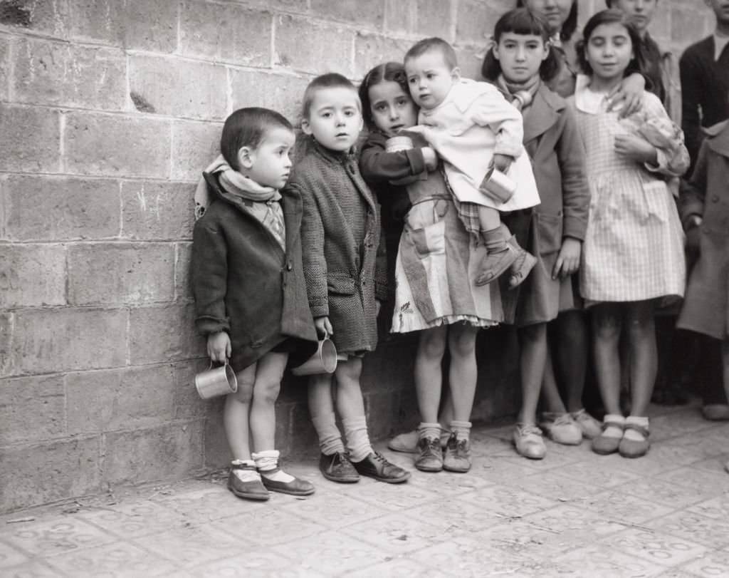 Children queuing for milk rations, Spanish Civil War (1936-1939), December 1937.