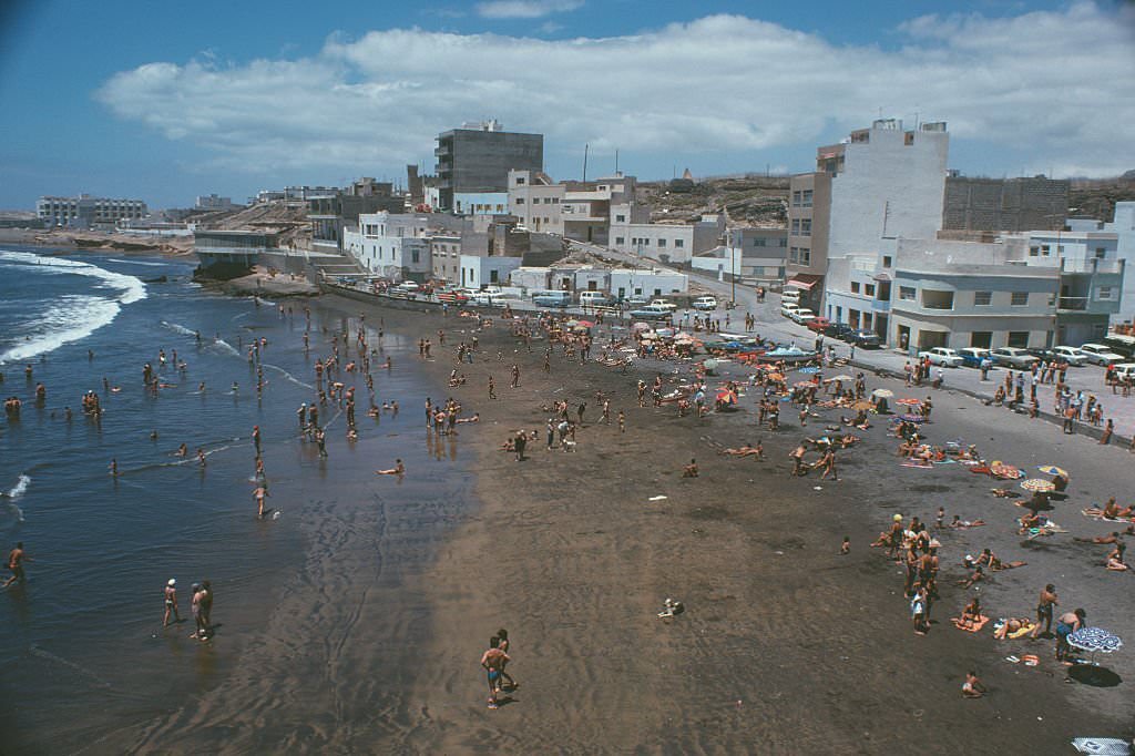 Sunbathers enjoying the beach at El Médano on Tenerife, Canary Islands, Spain, 1975.