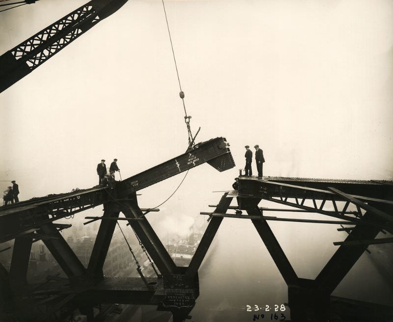 The Tyne Bridge arch is nearly complete as a girder is lowered into place above the River Tyne, February 23, 1928
