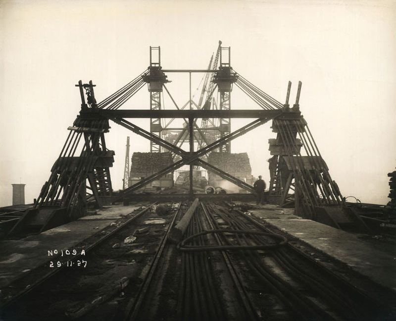 View of support mast and cables holding the Tyne Bridge in place as it is constructed, November 29, 1927