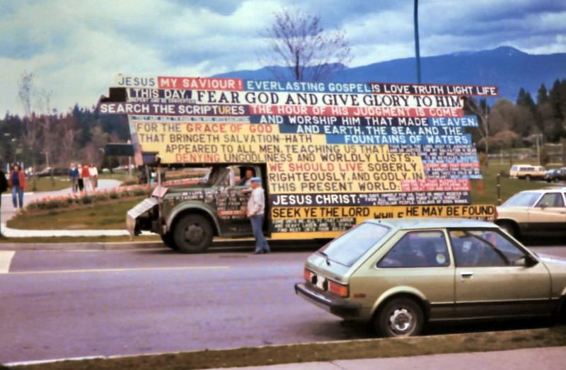 Truck with Christian religious signs parked near the entrance to Stanley Park at Denman and Georgia Streets, Vancouver, 1987