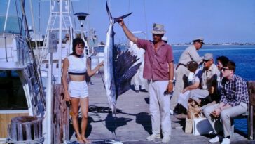 People posing with fishes 1960s