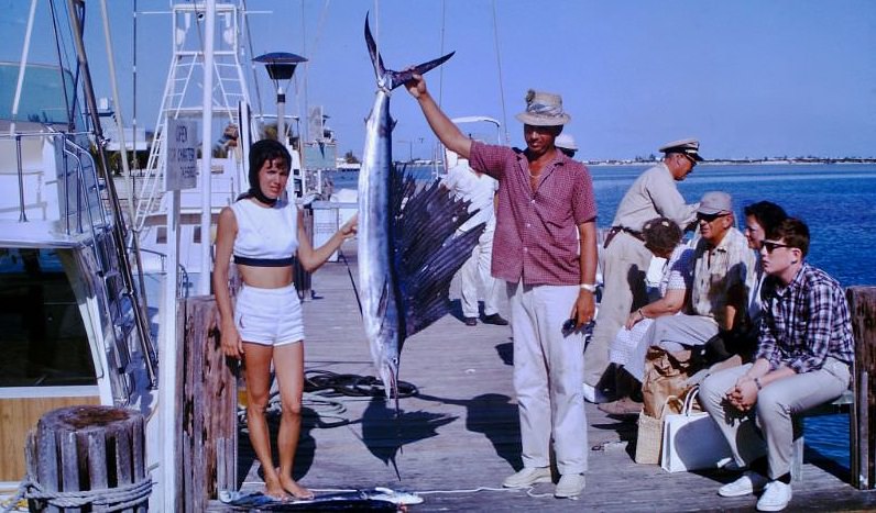 People posing with fishes 1960s