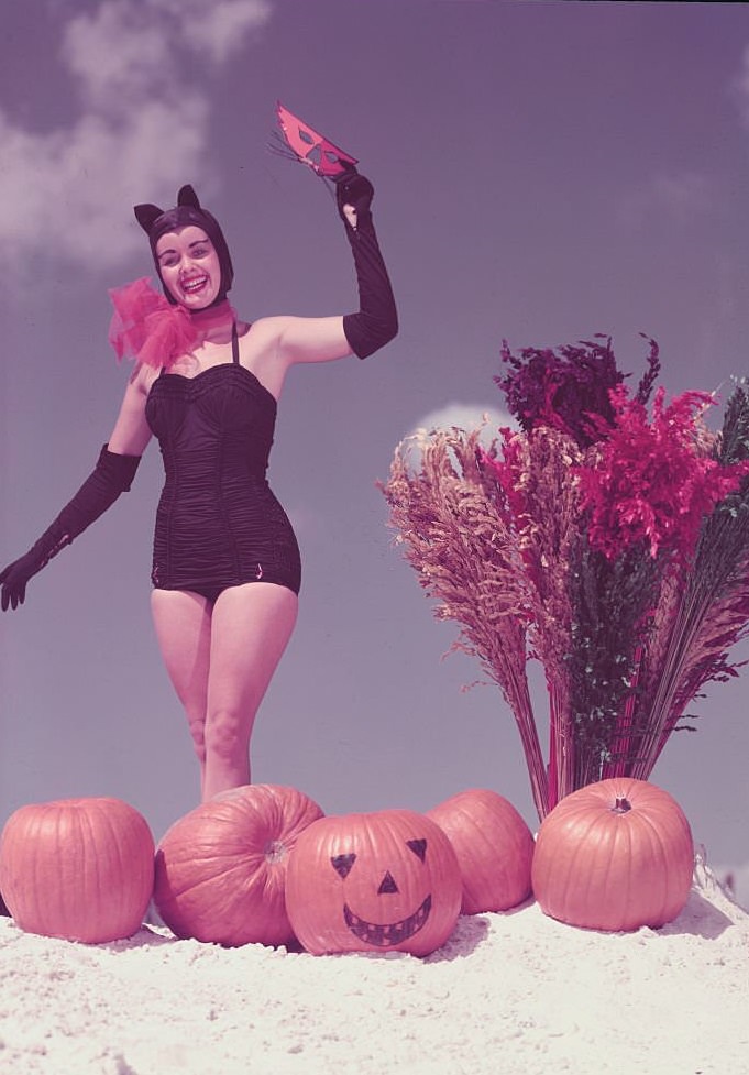 Young Woman in Costume Posing on Beach with Pumpkins at Winter Haven, Florida