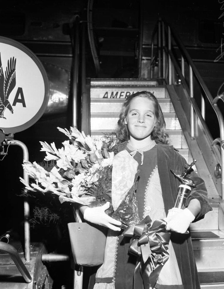 Martha Ann Williams from Long Beach returns home via American Airlines after 30 days tour competing in water skiing, 1957