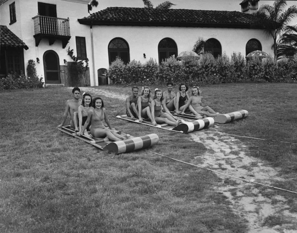 Water toboggans lie on a lawn ready to be pulled into the water by a boat at Cypress Gardens in Florida, 1943.
