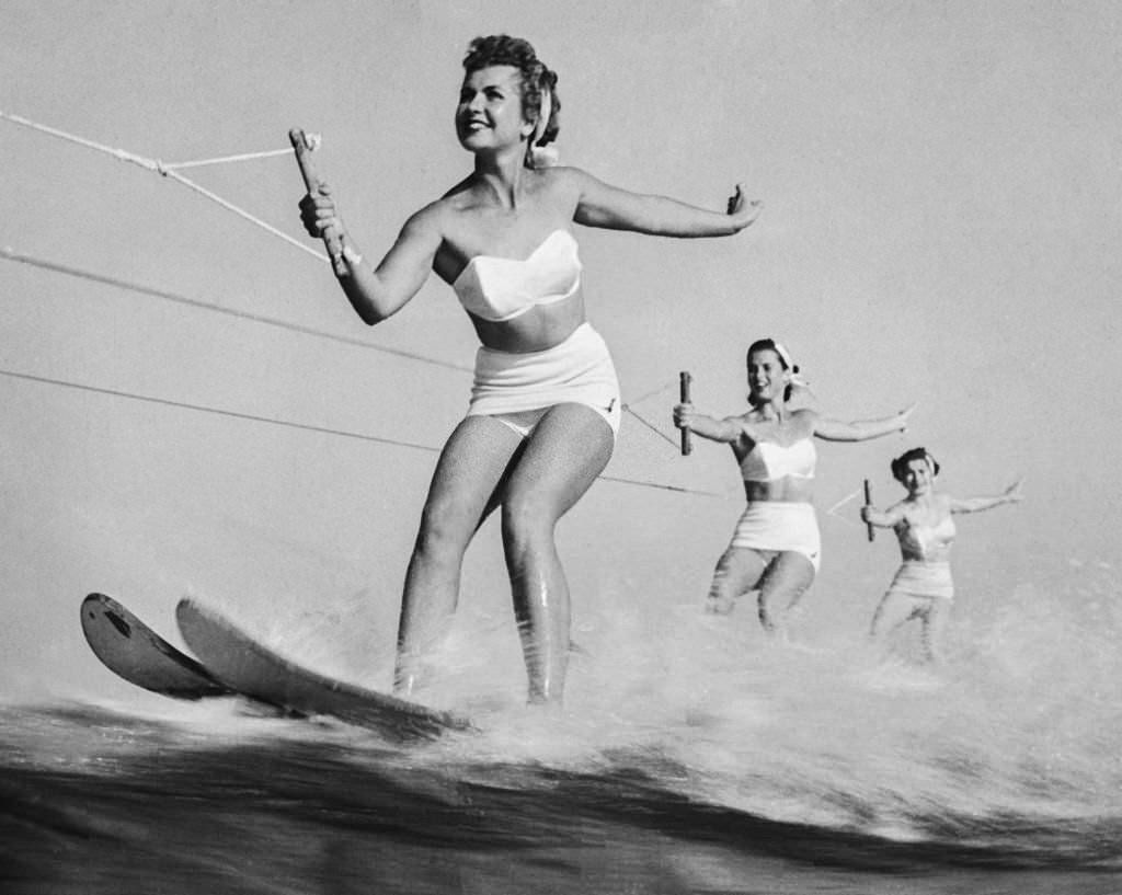 Joan Leslie leads a team of an aquatic parade over the waves of Cypress gardens, in the 1930s