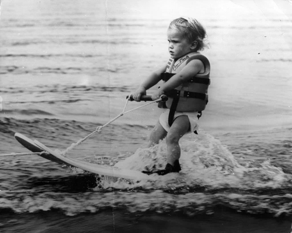 A 17-month old baby on water-skis at the Cypress Gardens Ski Centre in Florida.