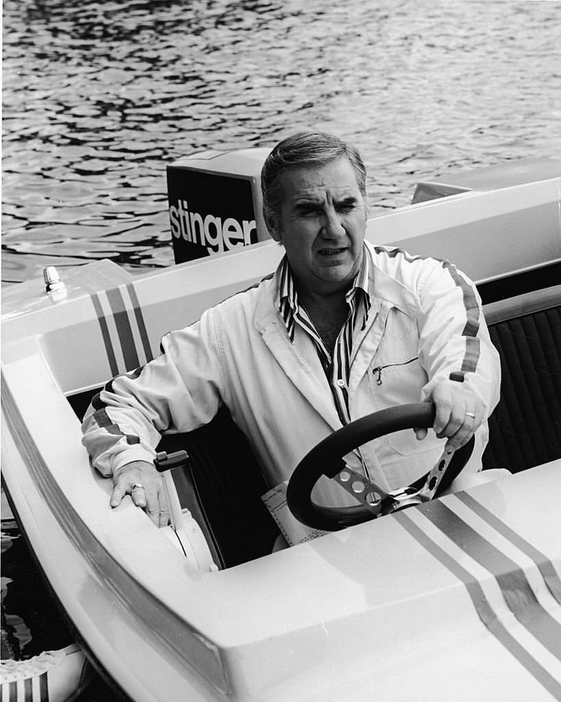 American television host Ed McMahon sits behind the steering wheel of a motorboat at Cypress Gardens, Florida, 1972.