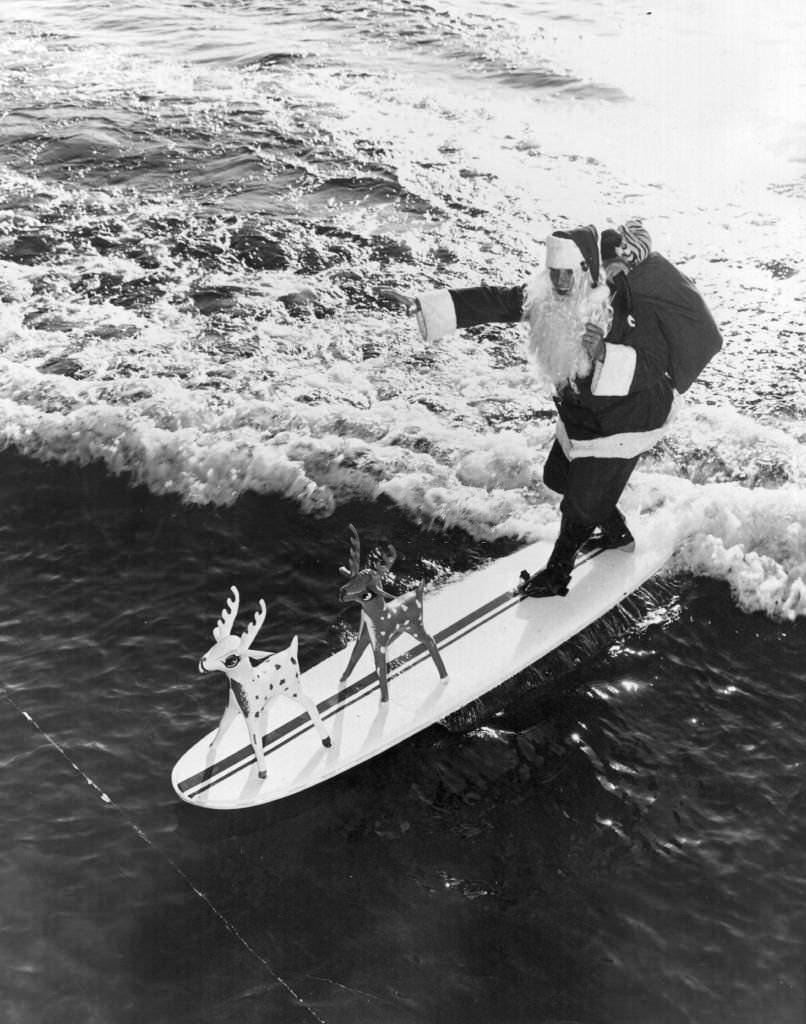 Father Christmas arrives at Cypress Gardens, Florida, on his surfboard, 1968