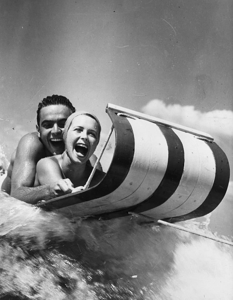 Two holidaymakers on a water toboggan at Cypress Gardens, Florida, 1968