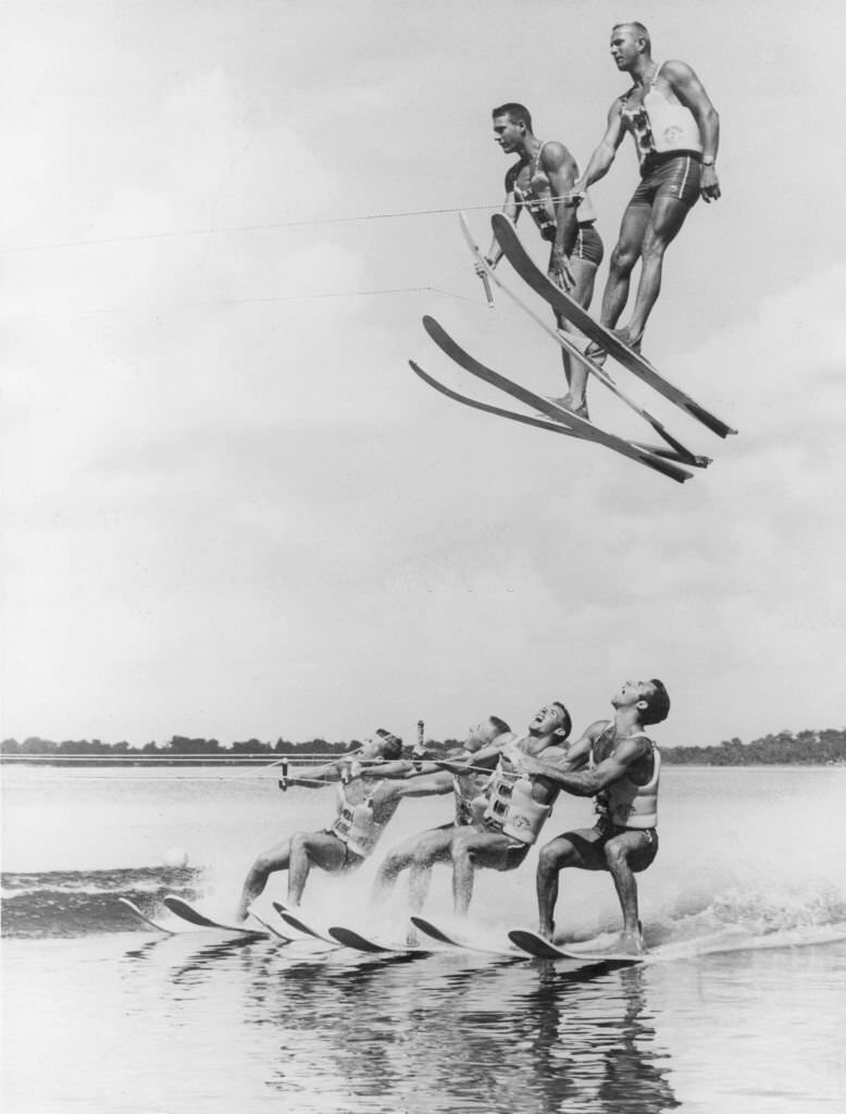 A high speed water-skiing team demonstrate advanced techniques of a stunt named 'flying high and dry', at Cypress Gardens, Florida, 1965