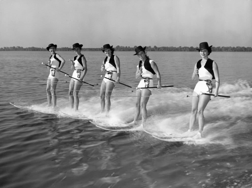 Five girls with six-shooters form the Cowgirl Water Posse, whose new water-skiing show 'Tough, Mighty Tough in the West' is causing a stir at Cypress Gardens, Florida, 1965