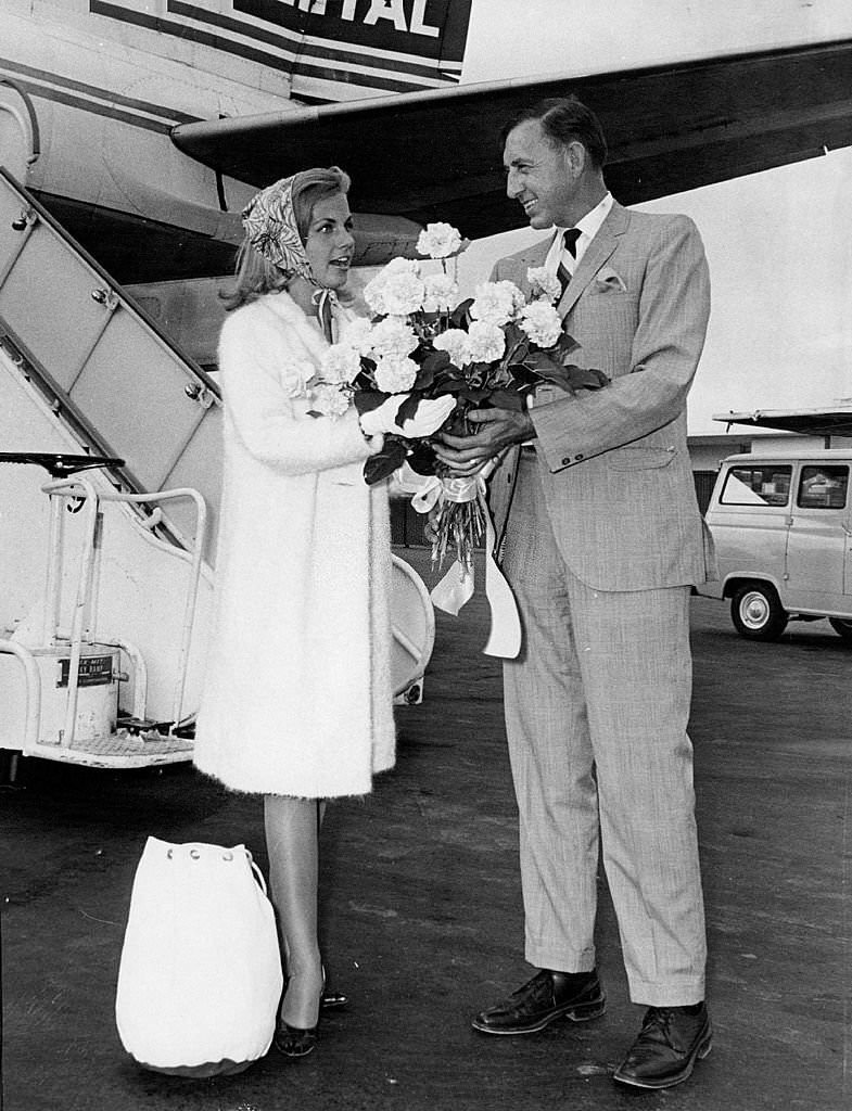 Smile Girl Welcomed Back; Paul Felix, vice president of the Denver Dry Goo, 1964