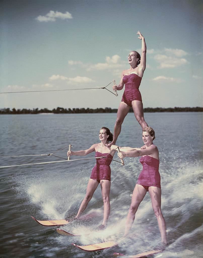 Water skiing champion Nancie Cooper, top, balances on two ladies during a water skiing acrobatic show at Cypress Gardens in Florida, 1956