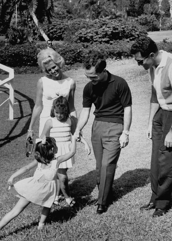 A curtsied welcome given to King Hussein Ibn Talal (2R), during his visit to Cypress Gardens.