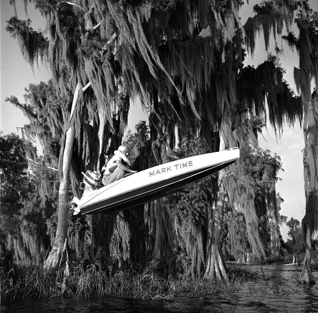 Mark Time takes his speedboat over the last hurdle in the Cypress Gardens racecourse, Florida, 1956