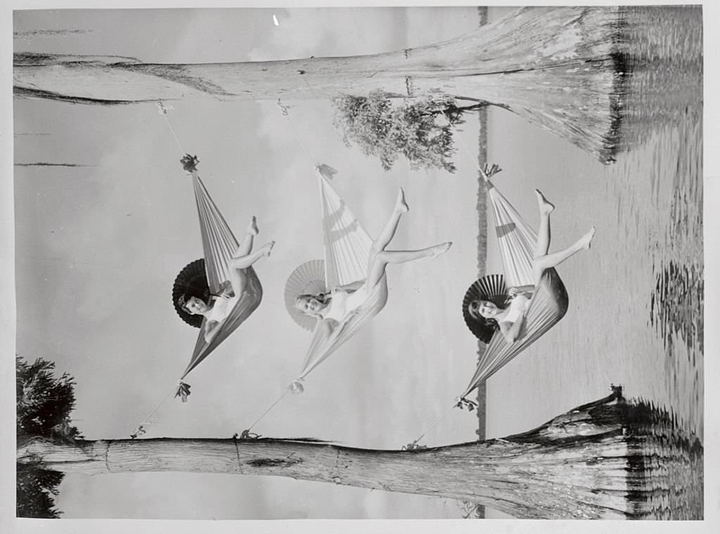 These gorgeous hammock swingers at Florida's Cypress Gardens show how they relax and stay "in the swing" of things at the same time.