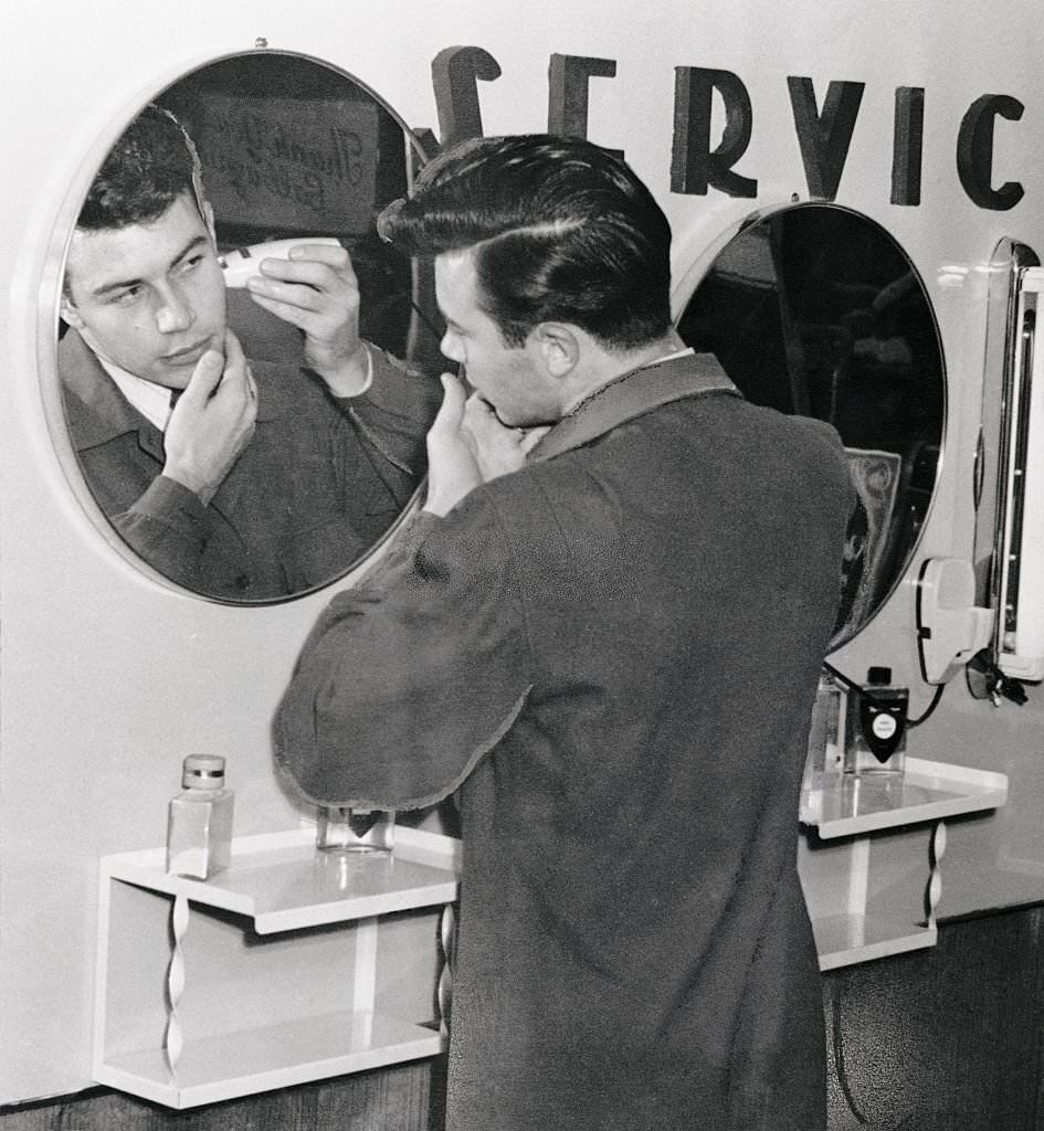 Man Shaving in Front of Mirror at Cypress Gardens, Florida.