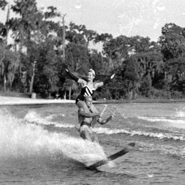 Couple ski at Cypress Gardens, Florida, 1950s.