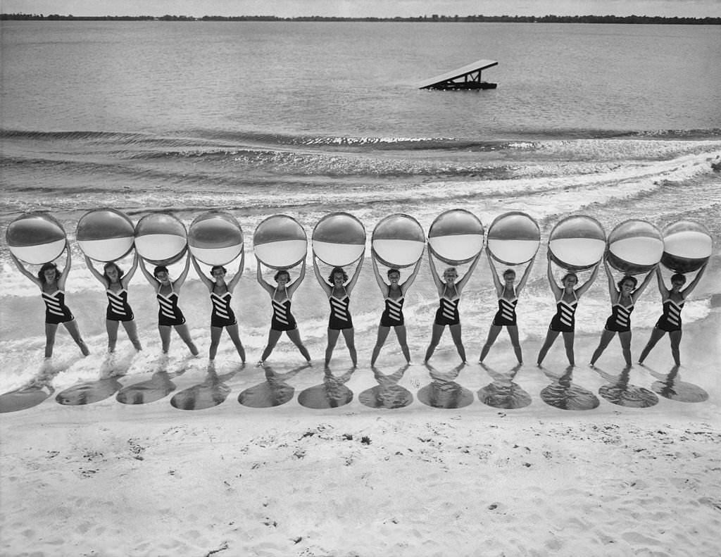 Women holding beach balls. Members of a show at Cypress Gardens, Florida, 1956