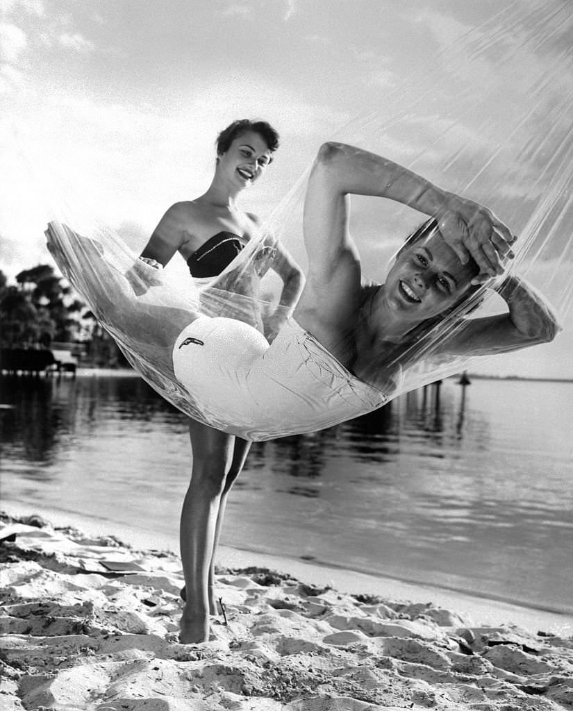 Joan Brown looks amost as if she's floating on air as she and Betty Bland (left) test a new plastic at Cypress Gardens, Florida, 1950s