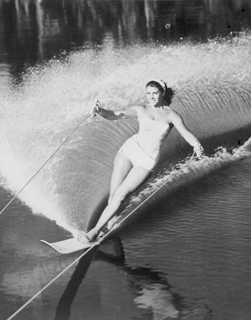 Splashing up a pretty spray at Cypress Gardens, Forida, is lovely Swiss water skier Marina Doria of Geneva.