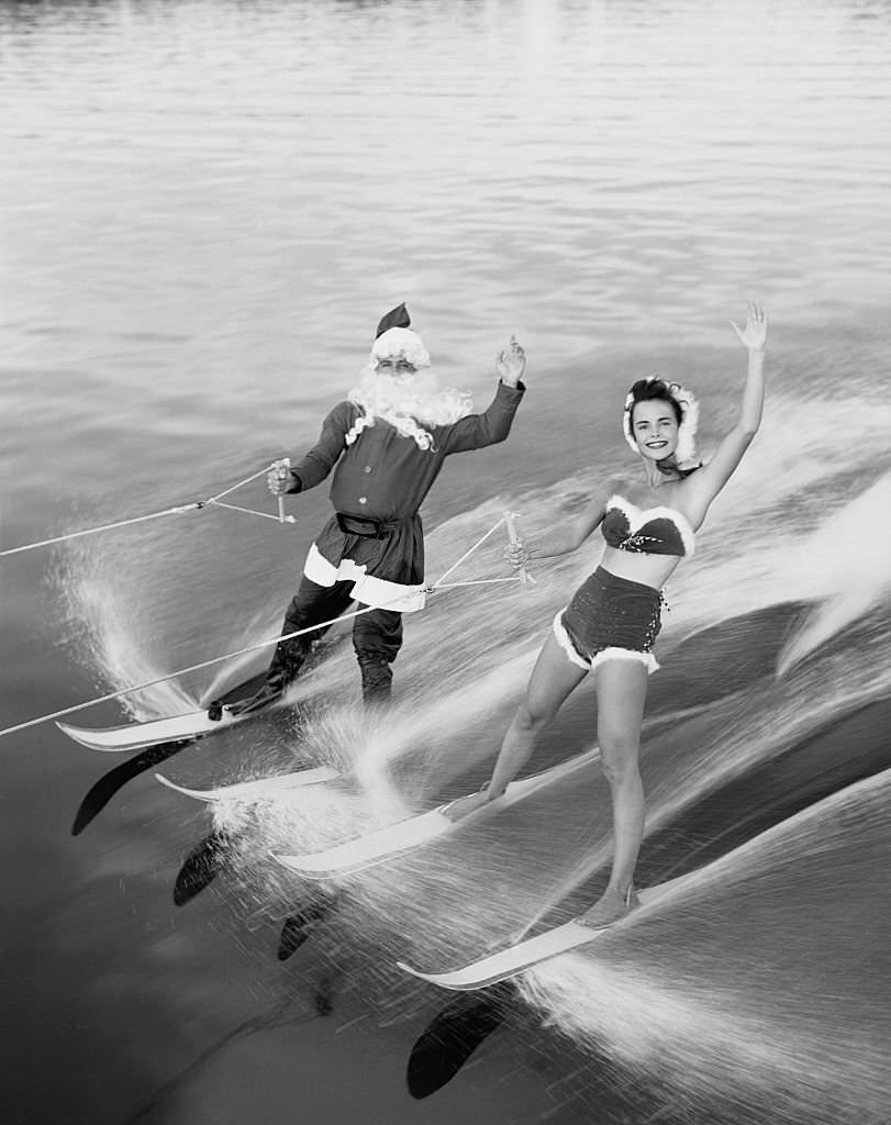 This Santa Claus helper has left Rudolph the Red-Nosed Reindeer and his sleigh up north and has taken to water skiing at Cypress Gardens, Florida.