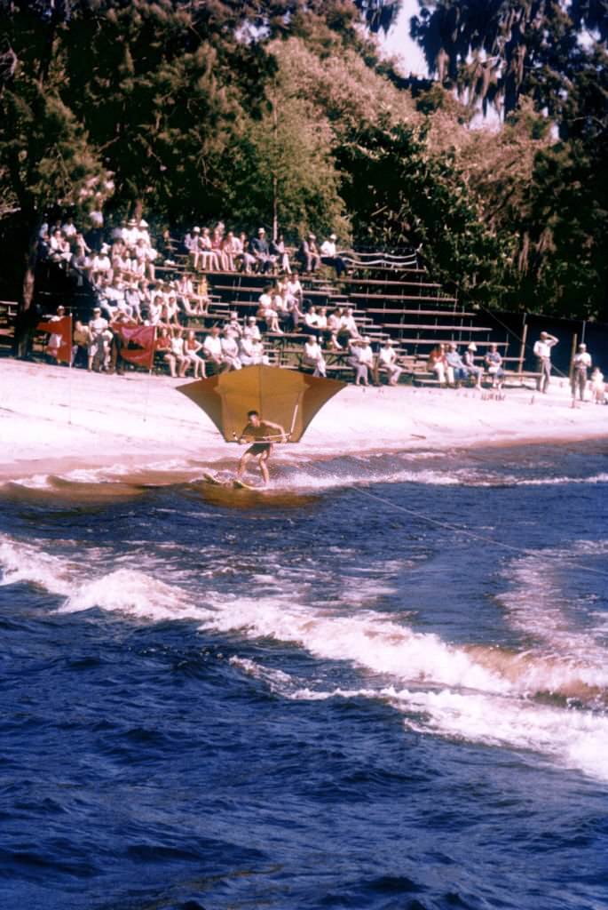 A small crowd watches an unidentified man water ski near the shoreline circa 1958 in Cypress Gardens, Florida.