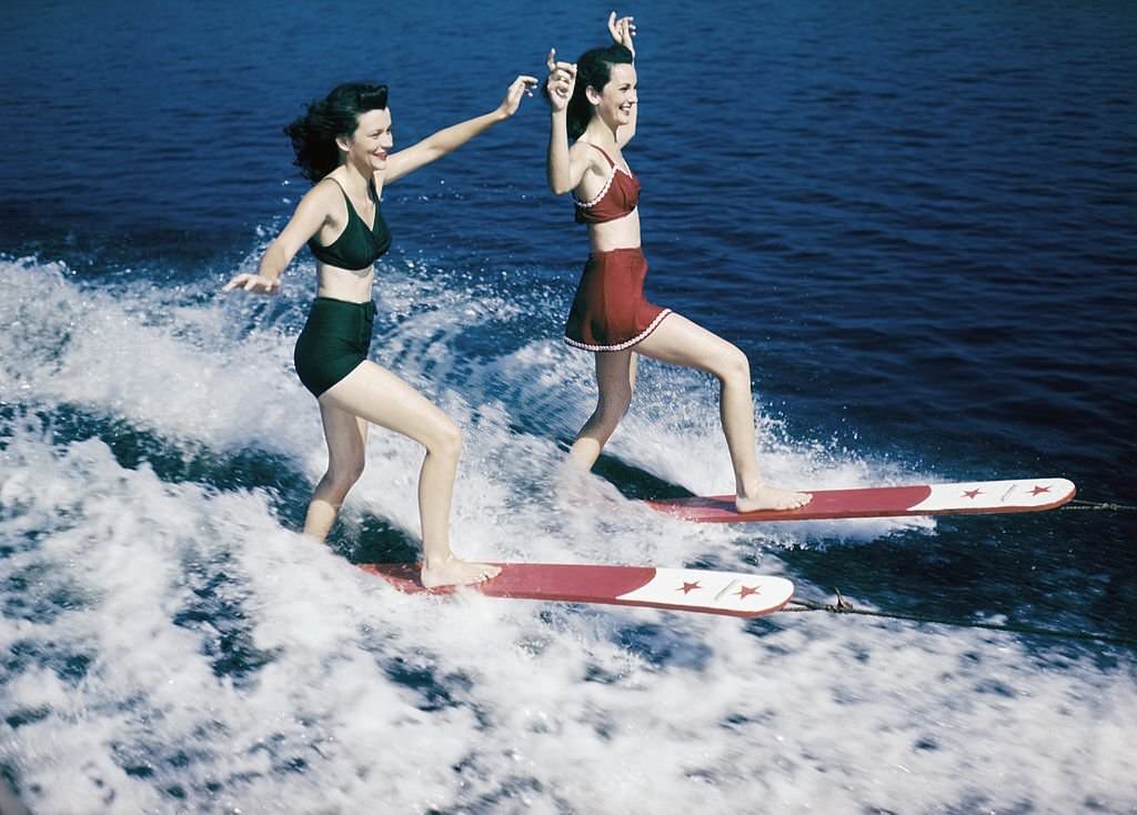 A pair of acrobatic water skiers perform during a show at Cypress Gardens theme park in 1953 near Winterhaven, Florida.