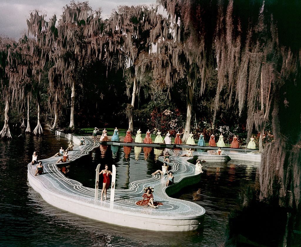 A group of southern belle models and aquatic film star Esther Williams (center holding water skis) pose for a portrait by a pool shaped like the state of Florida during the filming of 'Easy To Love' at Cypress Gardens theme park in 1953 near Winterhaven, Florida.