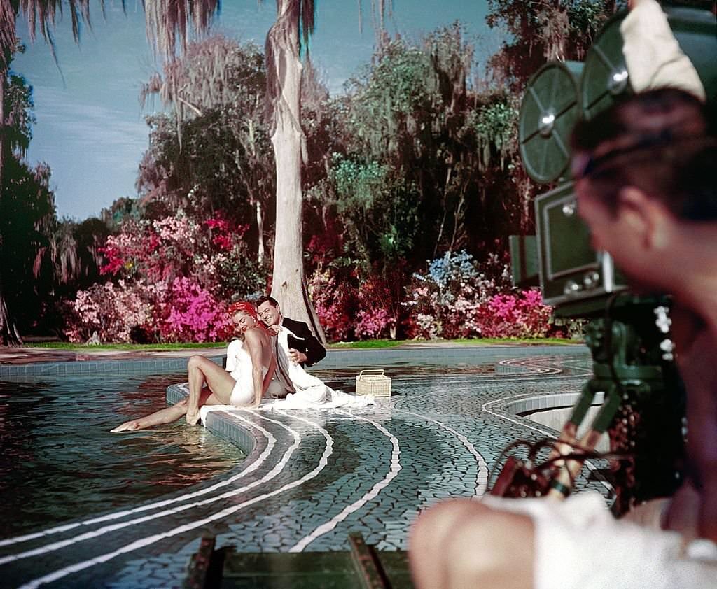 Aquatic film star Esther Williams and singer/actor Tony Martin perform during the filming of 'Easy To Love' at Cypress Gardens theme park in 1953 near Winterhaven, Florida.