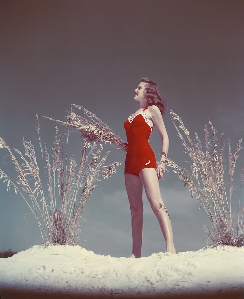 A southern belle model poses on the beach at Cypress Gardens theme park in 1953 near Winterhaven, Florida.