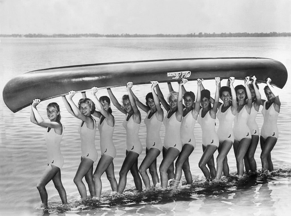 Women training by lifting a small boat on Lake Eloise, in Florida around 1950.