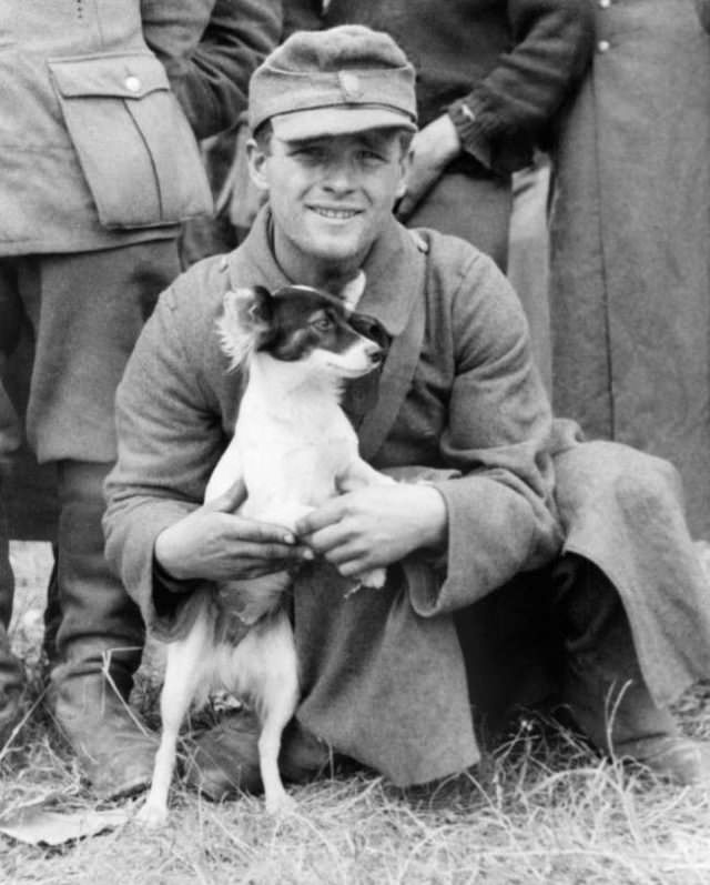This German soldier managed to keep his mascot dog when he was captured, with other members of his company, by allied troops in the beachhead sector in France on June 15, 1944.