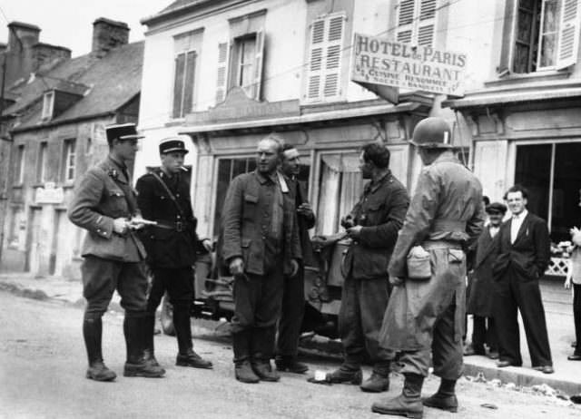 Two German soldiers surrendered to a solitary American soldier in Barneville, on the west coast of the Cherbourg peninsula, in France, on June 20, 1944.