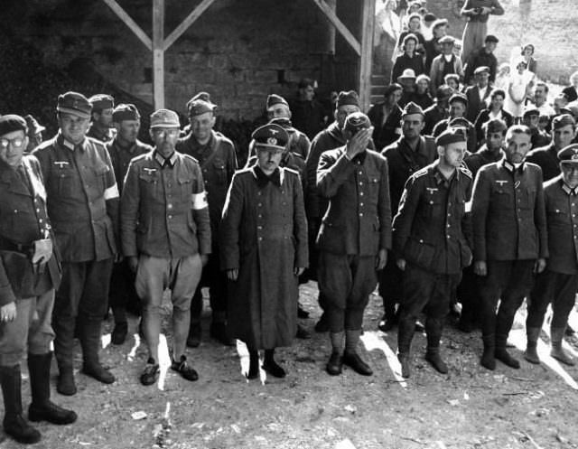 German prisoners captured by the FFI at Maizy sur Oise, France on Sept. 18, 1944 including officers of the Luftwaffe, stand in formation prior to being transferred to a detention area. Many of them are shoeless.