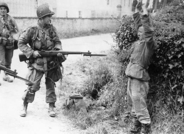 An American paratrooper holds a Nazi prisoner at the point of his bayonet, one of many incidents during the American advance into Normandy, in France, on June 10, 1944.