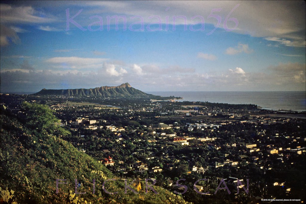 Late afternoon aerial view from Punchbowl Crater of Honolulu and Waikiki on south shore Oahu, 1950s.