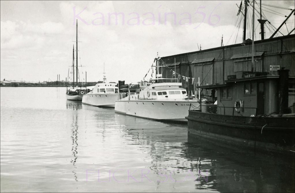 Power boats moored in Honolulu Harbor with Sand Island in the distance, 1949