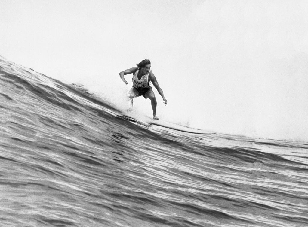 Hawaiian surfer Clyde Aikau sweeps down a 10-foot wave Sunday in the Smirnoff Pro-Am Surfing Classic.