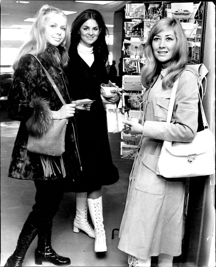 Miss P. August of S. Australia, Miss S. McElhinney of Victoria and Miss D. Van Emmerik shop for postcards during their stop at Sydney today.