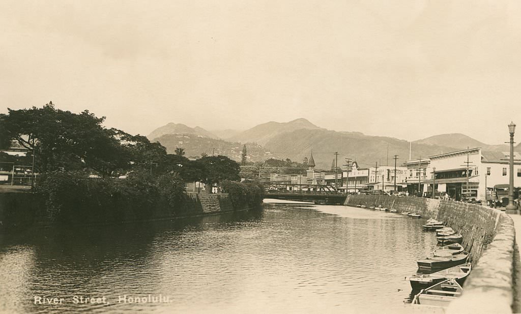 Canal lined with row boats and small buildings, 1940s