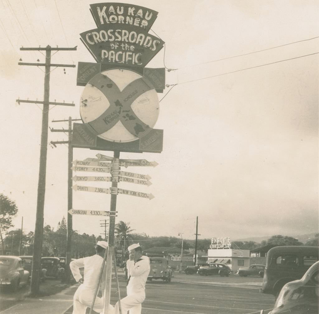 Sailors standing by Crossroads of the Pacific sign, 1940s