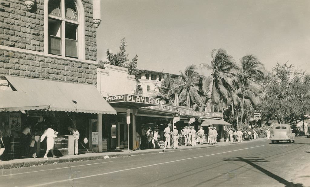 Servicemen on sidewalk in front of Playland awning, 1940s