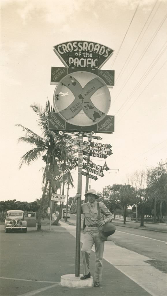 Soldier posing by Crossroads of the Pacific sign, 1940s