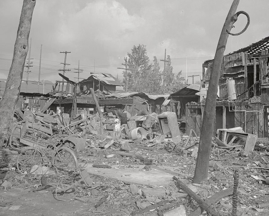 Bombs dropped from Japanese planes rained suddenly out of the skies on December 7, 1941, leaving a wake of death and ruins on this Pacific Ocean outpost of the United States, a scene of devastation in suburban Wakiki Beach, a favorite resort spot of tourists from the island.