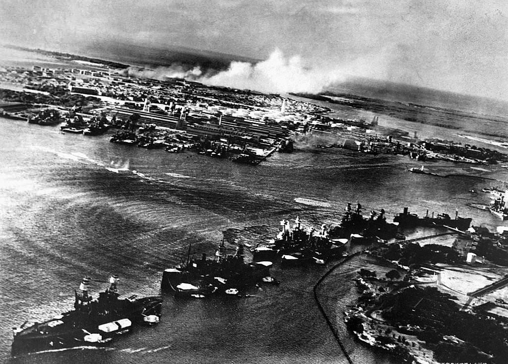 Military facilities and ships at Pearl Harbor burn during a Japanese attack on December 7, 1941.