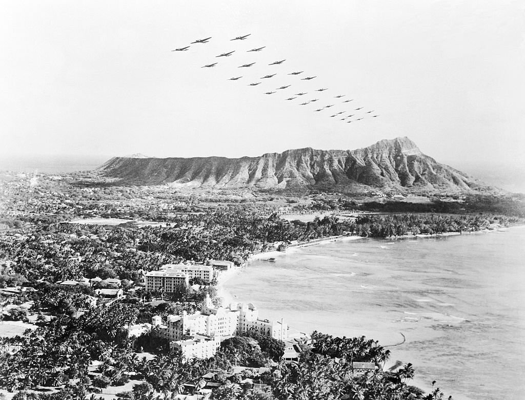 The White House announced that Japanese planes attacked Hawaii. Soon after as shown here, U. S. medium bombers fly over diamond Head and beautiful Wakiki Beach at Honolulu.