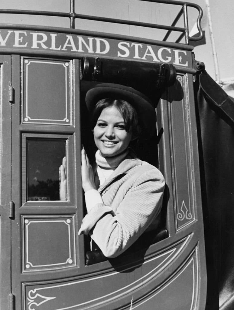 Actress Claudia Cardinale sitting in a Stage Coach, as she appears in the film 'Circus World', Spain, November 27th 1963.